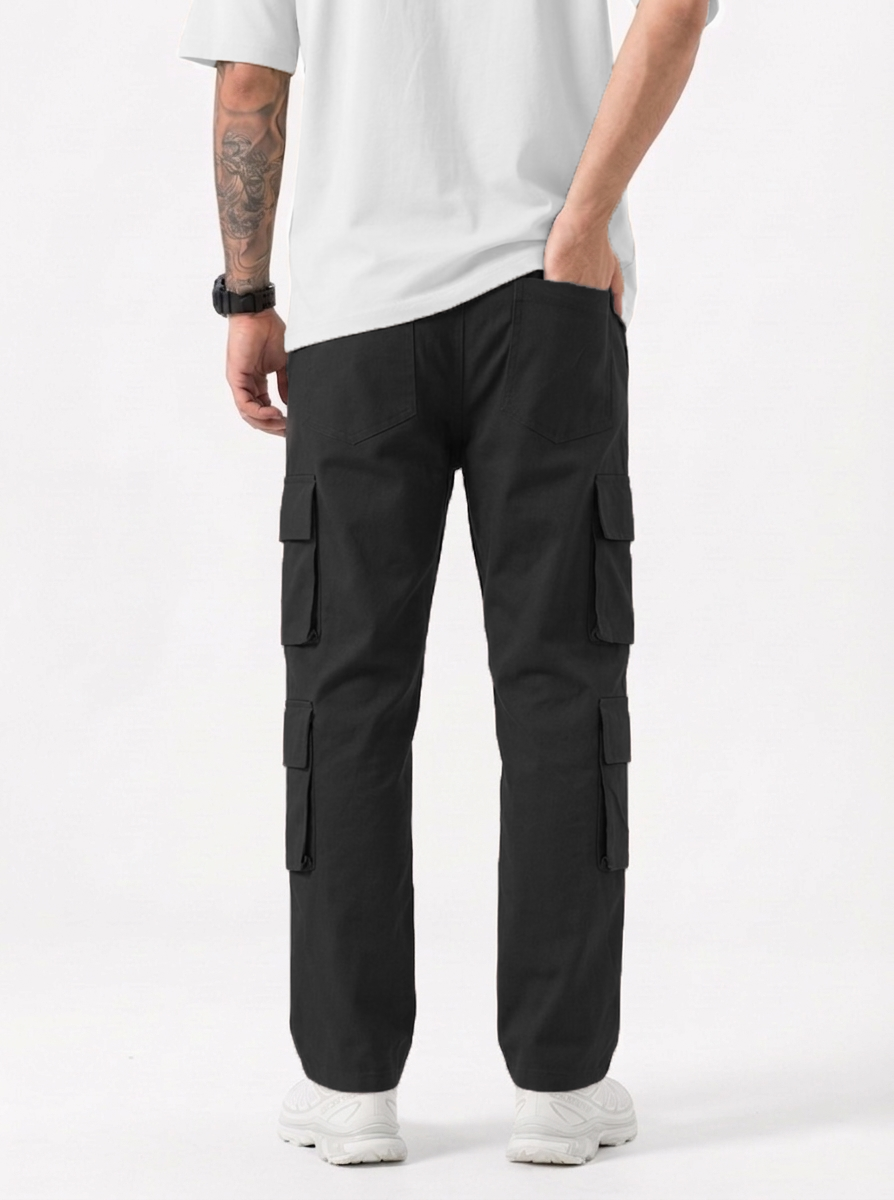 Person wearing black cargo pants and a white shirt on a white background