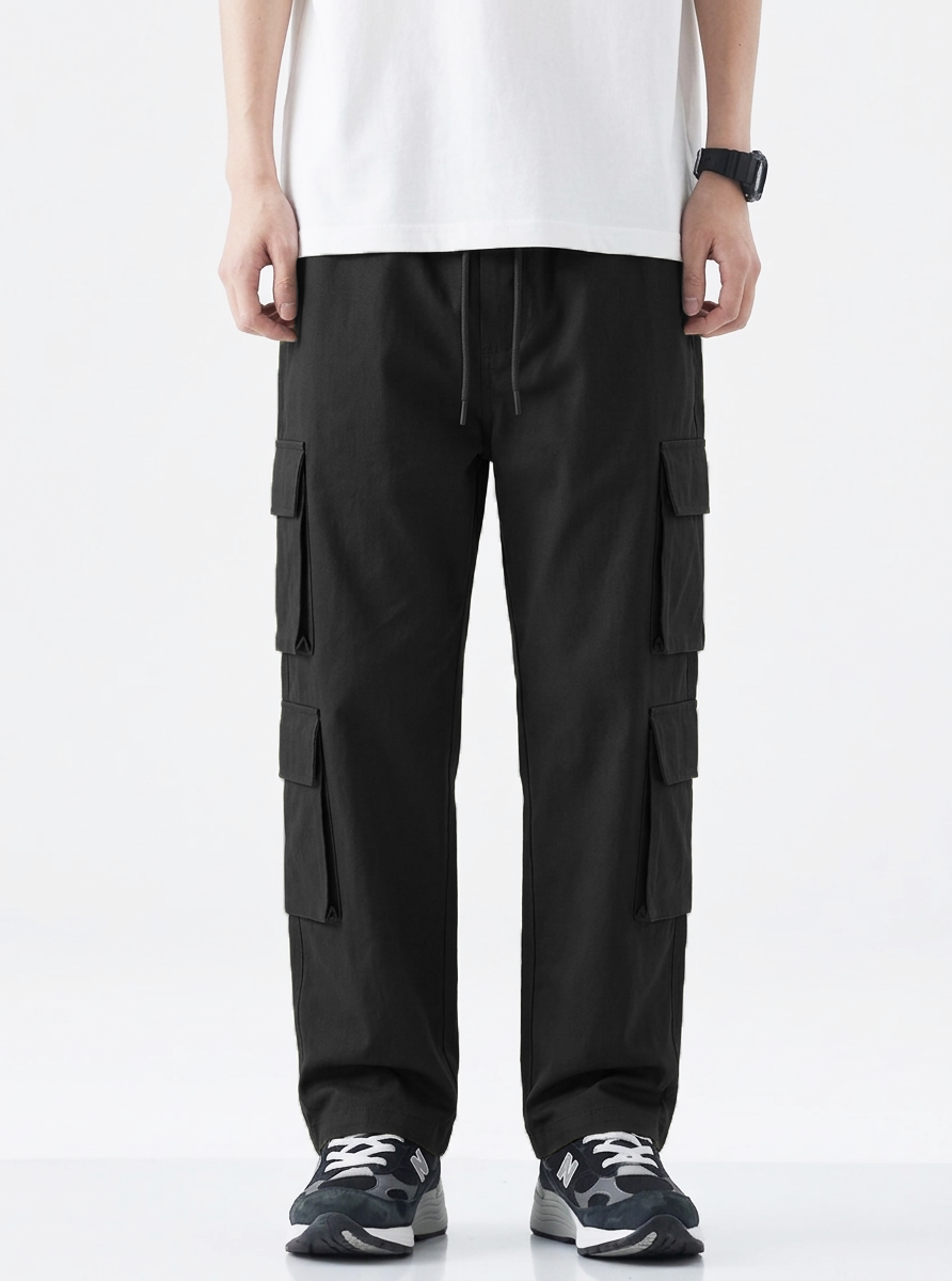 Person wearing black cargo pants on a white background