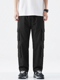 Person wearing black cargo pants on a white background