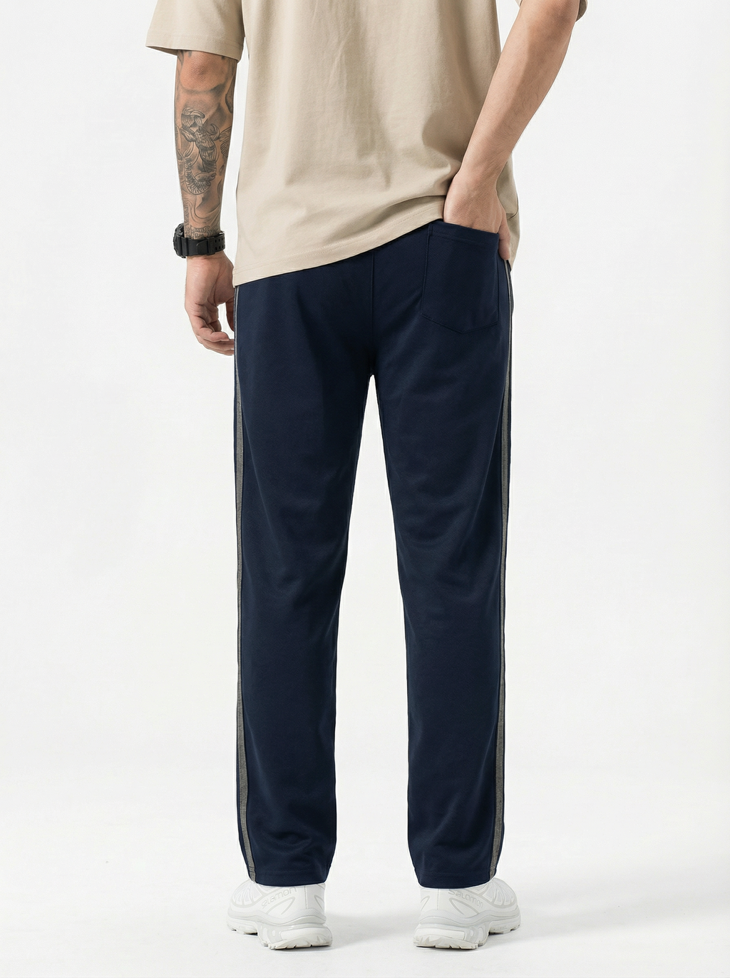 navy track pants with a white background