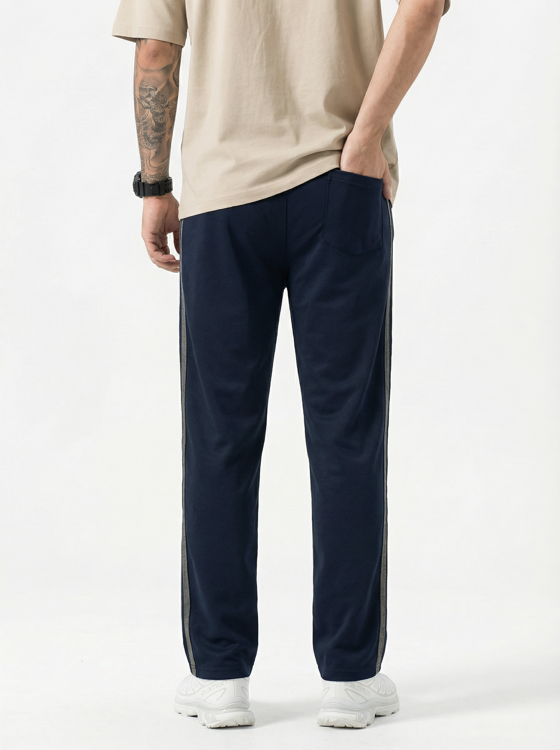navy track pants with a white background